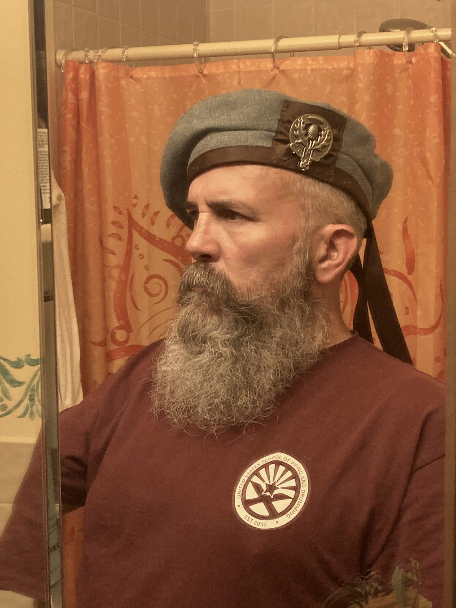 A customer in a gray wool bonnet, in profile
